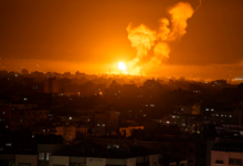 Fire and smoke rise following an Israeli airstrike in the central Gaza Strip on Friday.Fatima Shbair / AP