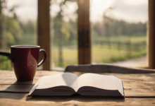 AI-generated image: A wooden table with a red mug and an open book is the main subject.