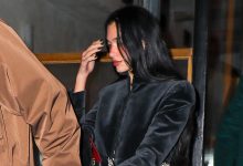 Dua Lipa wearing a cropped black velvet jacket with dark denim jeans and zebra-print pumps in NYC