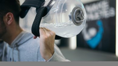 Fitness enthusiast uses unique water jug for exercise in modern gym during evening workout session.jpg