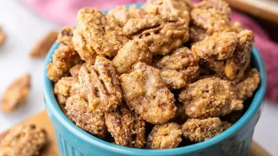 Close-up view of a blue ramekin filled with candied pecans.