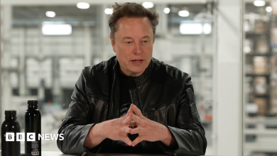 Elon Musk, in a black leather jacket, speaking about SpaceX's quarterly business performance in a livestream.