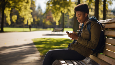 AI-generated image: A young Black woman is sitting on a wooden park bench, holding a smartphone in her hands.
