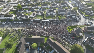 A drone shot of the rally gathered at the mouth of Drumcree Road into the north end of Garvaghy Road on 3 October.png
