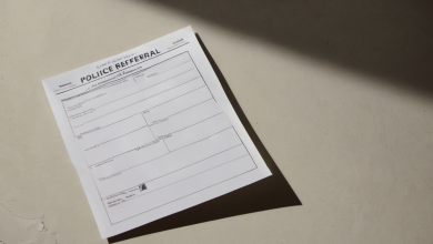 AI-generated image: A white police referral form is lying on a beige surface.