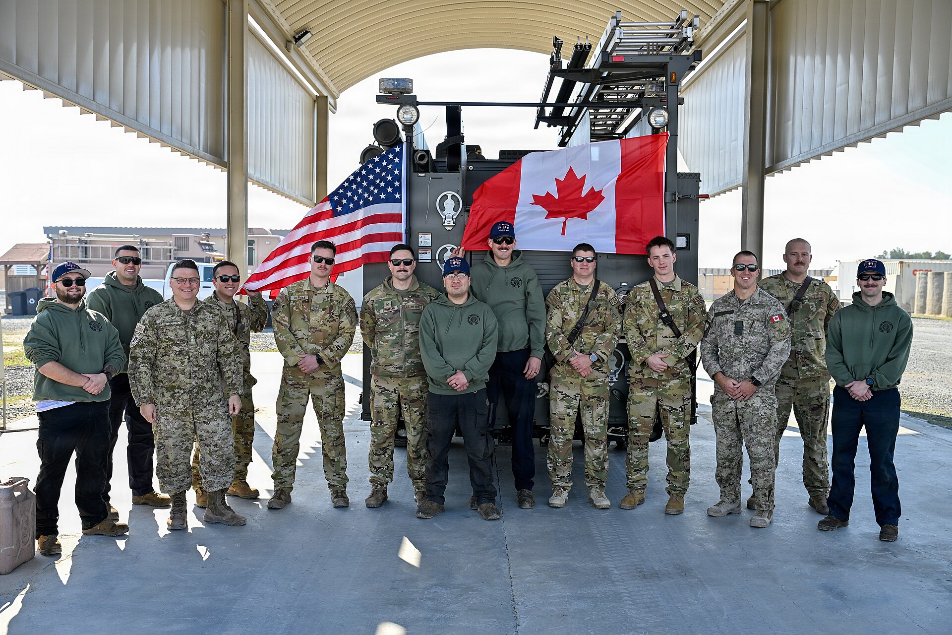 386th Air Expeditionary Wing and Canadian Coalition Partner Conduct a Ceremonial Fire Truck Push (9523597).jpg