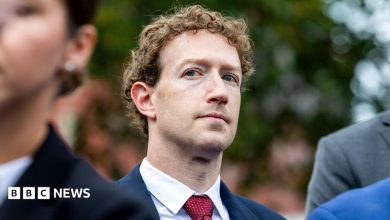 Meta CEO Mark Zuckerberg standing outside of the White House, looking to the side, while surrounded by security people.