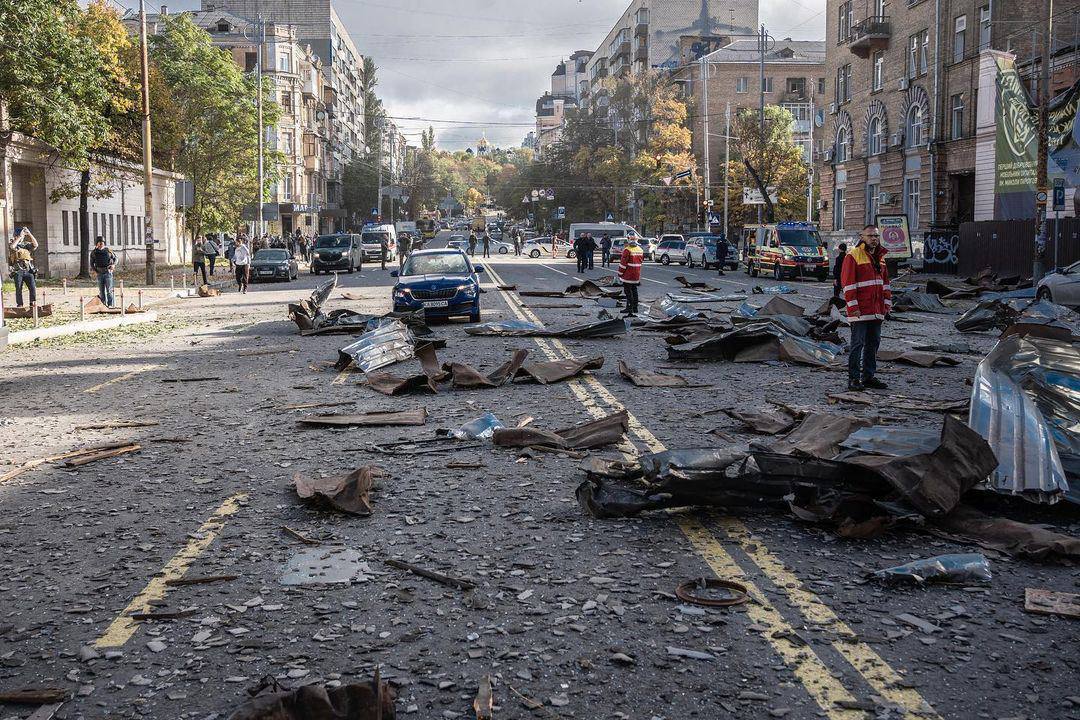 Damaged bridge in Kyiv, Ukraine, at night with smoke and debris