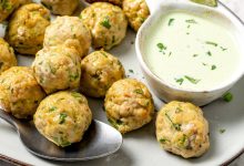 Platter of baked southwest turkey meatballs with bowl of creamy dipping sauce.