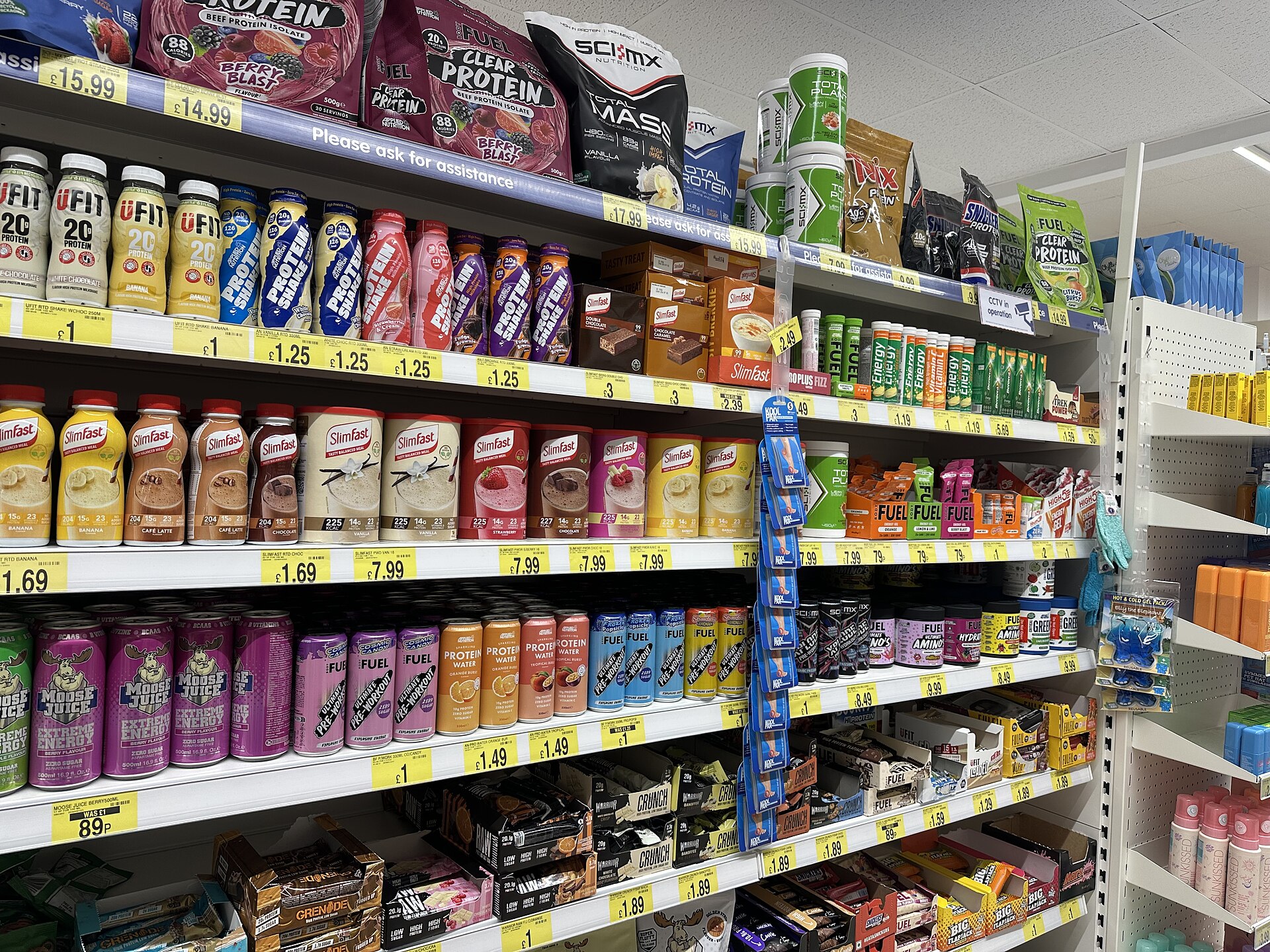 Shelves with protein drinks, supplements, and other packaged foods at B&M (134-142 High Street, Gillingham, Kent ME7 1AS).jpg