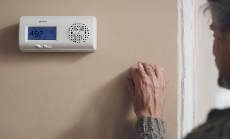 AI-generated image: A close-up shot of a wall with a digital thermostat mounted on it.